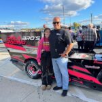 Gillian and her father Rick in front of her race car.