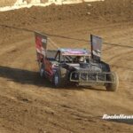 Gillian racing on a dirt track.